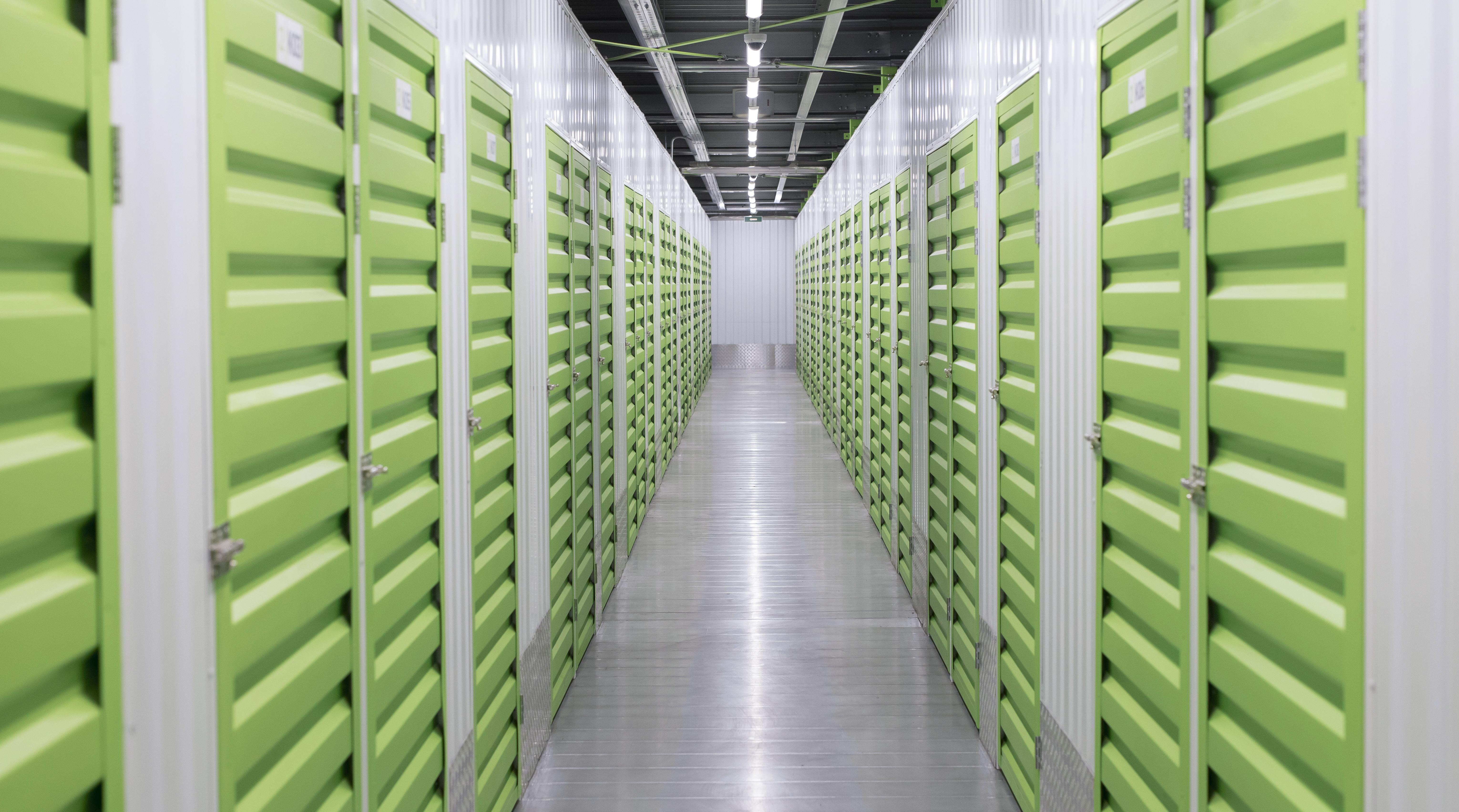 Self-storage facility interior with green louvered unit doors